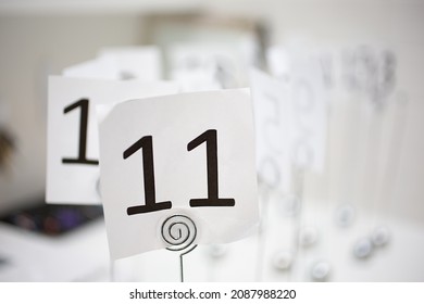 A View Of A Restaurant Number Holder On A Table, Number 11.