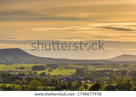 View of the Ribble Valley from the top of Clitheroe castle. Large valley with a warm summer sky