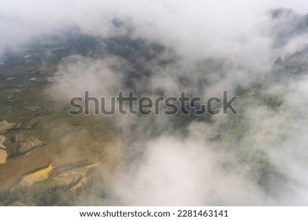 View of rice fields on terraced, hills, forest with misty and fog, view from cable car to Mount Fansipan, travel and landscape concept.