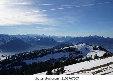 View from Rigi mountain in Canton Schwyz, Switzerland in winter. On the horizon there are peaks of Swiss Alps mountains, partly covered with snow and Lake Lucerne underneath.