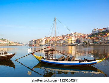 View of river Douro with the traditional wooden boat,  Porto city in the background, Portugal.