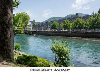 View Of The River Gave De Pau In Lourdes, France. The Sanctuary At Lourdes. 