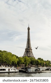 A view of the river Seine and the Eiffel tower under a cloudy sky in Paris, France.