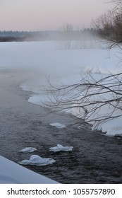 View of the river in the spring evening. By evening, colder, fog rises from the surface of the water where the snow was melted.