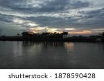 a view of the river with a sunset background behind the trees