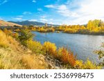 View from the Riverfront Trail along the Clark Fork River of the University District and tower of the Boone Crockett Club Natural History Museum in downtown Missoula, Montana.