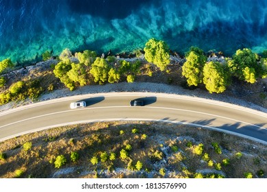 View of the road along the coast from the drone. Travel by car in summer time. The sea coast and the road. The coast of Europe.