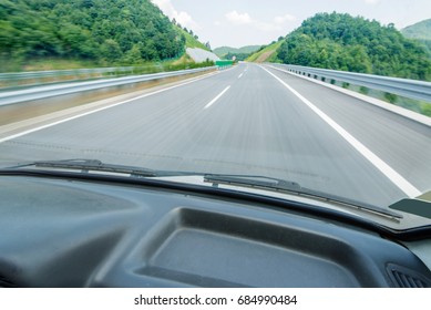 View Of The Road Through The Windshield Of The Car