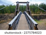 A view of the Robert Lowe suspension bridge, located in Miles Canyon, Yukon, Canada.  This bridge crosses the Yukon River as it makes its way into Whitehorse, part of the Klondike Gold Rush Trail.