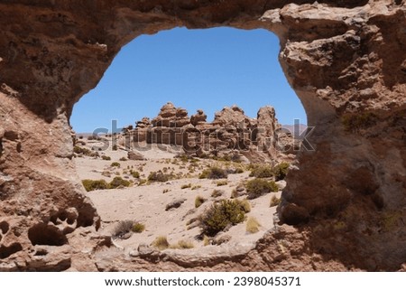 View of rock formations through a hole in a rock.  Location: Bosque de Piedras, Bolivia, Laguna Route, stone forest.
