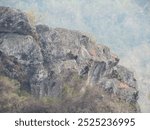 view of rock textured hilltop with dry grass