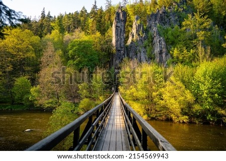 View of the Svatošské rocks and the bridge on the banks of the River Ohře. National Nature Monument during sunset 