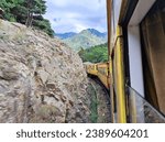 View of the rocks and mountains from the running Train Jaune in the French Pyrenees 