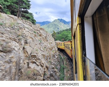 View of the rocks and mountains from the running Train Jaune in the French Pyrenees 