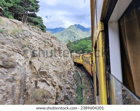 View of the rocks and mountains from the running Train Jaune in the French Pyrenees 