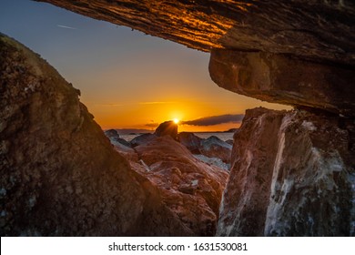 View from rocks as sun setting below the sea