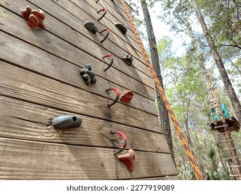 A view of a rocky climbing wall, part of an obstacle course. - Powered by Shutterstock