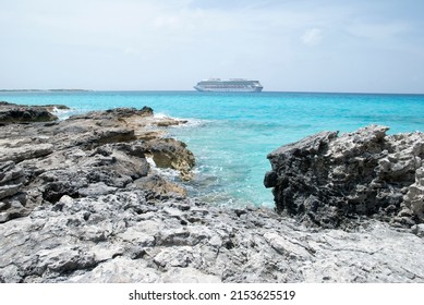 The View Or A Rocky Half Moon Cay Shore And A Drifting Cruise Ship In A Background (Bahamas).