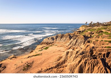 View of rocky sunny cliffs, waves and blue horizon at Sunset Cliffs, in Point Loma, San Diego, California - Powered by Shutterstock