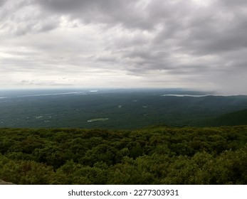 View of rolling green mountain range, with an overcast sky. Taken in the Catskills, a mountain range that is part of the northernmost reaches of the Appalachia.