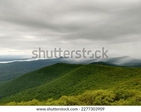 View of rolling green mountain range, with an overcast sky. Taken in the Catskills, a mountain range that is part of the northernmost reaches of the Appalachia.