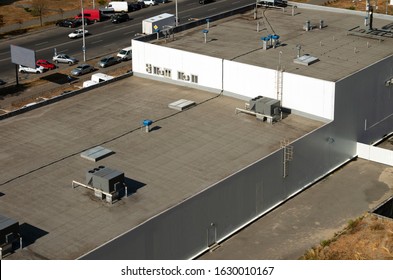 View of the roof of a commercial building in the middle of the city.