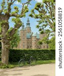 View of the Rosenborg Palace in Copenhagen, Denmark. Summer. Bicycle parked at city park in center.