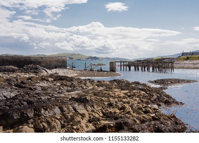 View Of The Rotting Piles Forming The Old Peir At Ellenabeich, Isle Of Seil, Scotland