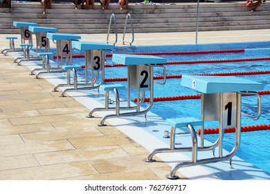 View of a row of diving boards in a pool.