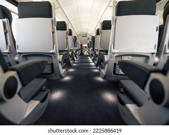 View of row of empty seats. Interior of modern passenger train. Mode of railroad, railway, train transport.