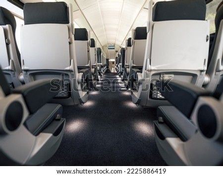 View of row of empty seats. Interior of modern passenger train. Mode of railroad, railway, train transport.