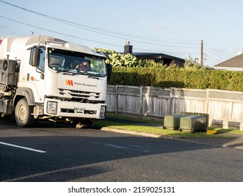 View Of Rubbish Truck Collecting Wheelie Bins Toppled By Strong Wind. Auckland, New Zealand - May 20, 2022