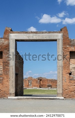 View of ruins of the city Pompeii in Italy. View of the entrance to the  Portico of Concordia Augusta or Building of Eumachia on Forum.
