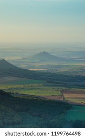 View To The Ruins Of Hazmburk In Czech Central Massive Captured From Milesovka Hill In September Morning.