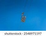 View of the Saentis aerial cableway cabin against blue sky from below at Schwaegalp, Canton of Appenzell Ausserrhoden, Switzerland