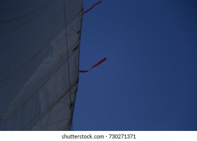 View of a sail from the deck of a large sailing yacht.