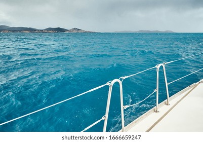 The View From The Sailboat On The Sea And Mountains, A Boat Board, Slings And Ropes, A Sail, Splashes From Under The Boat, Improbable Azure Water, Comes Nearer A Storm