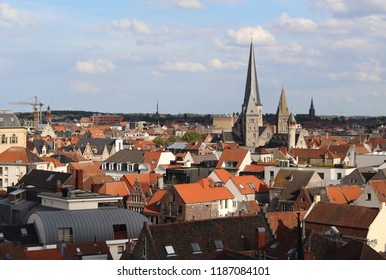 View of Saint James church and the roofs of the historic center of Ghent on a sunny day.