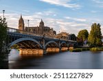 View of Salamanca (Spain) at sunset, with the cathedral and the Enrique Estevan bridge from the viewpoint of the pier on the Tormes river