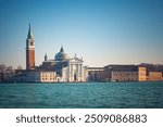 View of San Giorgio Maggiore Island with its iconic church and bell tower across the water in Venice.