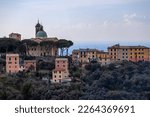 View of San Rocco di Camogli church with some colored buildings in Camogli, province of Genova, Italy