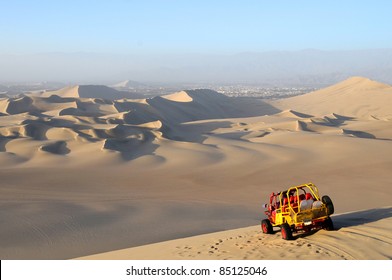 View of Sand Dessert with Dune Buggy in foreground