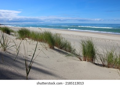 View of a sand dune with a strip of grass, the Baltic Sea - Shutterstock ID 2185113013