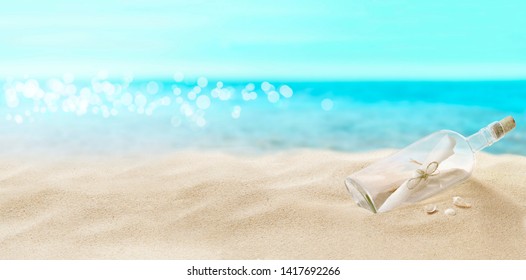 View of the sandy beach. Bottle with a letter inside. - Shutterstock ID 1417692266