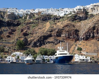 View Of Santorini Island  Capped With White Buildings From The Blue Water Below