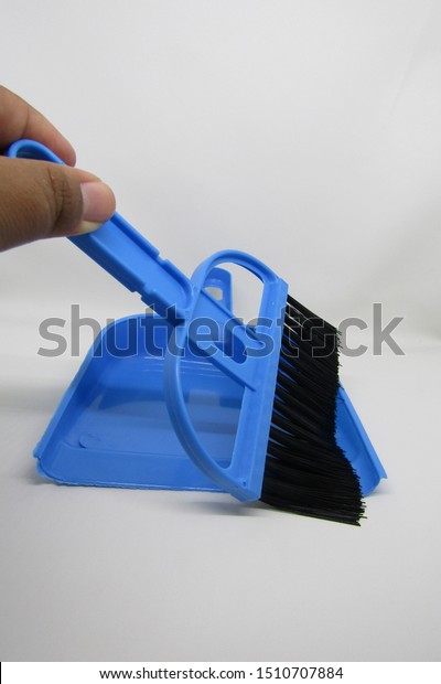 View of sapu mini serok cikrak or bikrak sewer broom\
equipped with dustpan set. Has color blue handle and black smooth\
fur. Can clean in small places such as in cars, rooms, electronic\
devices. 