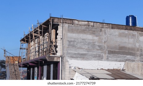 View Of A School Building Under Construction Against A Clear Blue Sky Background