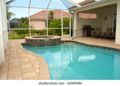 View Of Screened In Pool And Lanai Or Patio In Florida With Blue Sky And Sitting Area