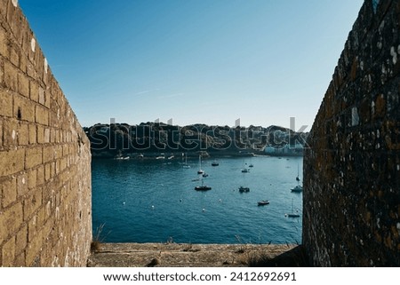 View of the sea and coastline from a castle on the shore in Guernsey
