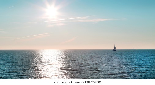 View Of The Sea, The Ocean With A Sailboat On The Horizon And The Bright Sun And A Sunny Path On A Clear Day. Landscape Travel Landscape Sights Of Europe.